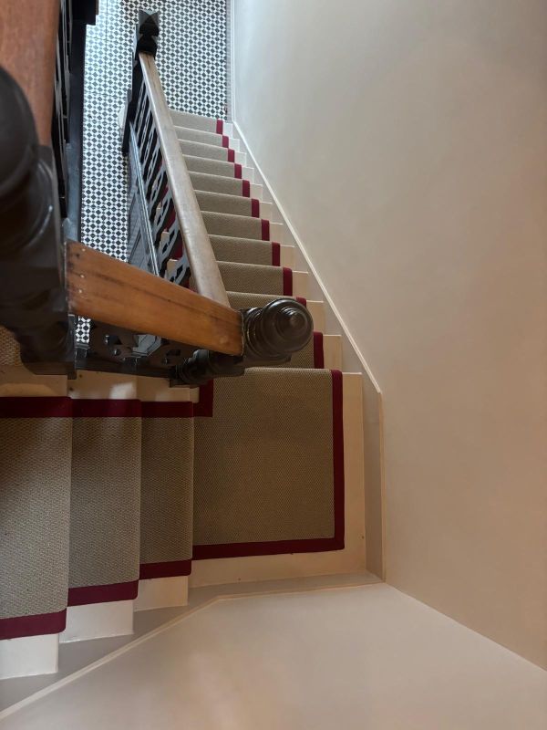 Close up of stair runner fitted in woodford IG8 of a stair runner in Victoria Sisal Weave Buckwheat